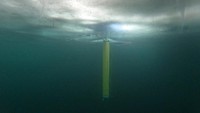 A remote camera captured an IceNode prototype deployed below the frozen surface of Lake Superior, off Michigans Upper Peninsula, during a field test in 2022. The three thin legs of the robots 
