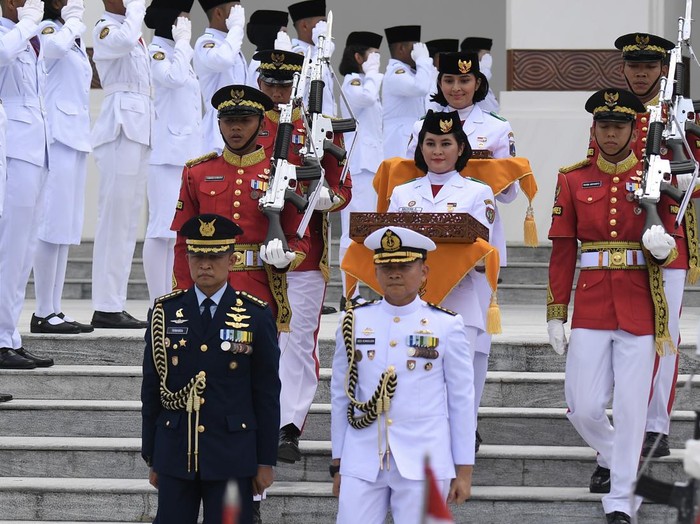 Tim Purna Paskibraka 2023 Kachina Ozora (tengah) membawa duplikat bendera Pusaka Merah Putih dan anggota Paskibraka 2024 Sabrina Roihanah (belakang tengah) membawa salinan naskah teks proklamasi berjalan meninggalkan Istana Negara Ibu Kota Nusantara (IKN), Penajam Paser Utara, Kalimantan Timur, Sabtu (31/8/2024). Duplikat bendera pusaka dan naskah teks proklamasi tersebut kembali ke Monumen Nasional (Monas) Jakarta seusai digunakan pada upacara kenegaraan peringatan detik- detik Proklamasi Kemerdekaan Republik Indonesia di IKN pada 17 Agustus 2024 lalu. ANTARA FOTO/M Risyal Hidayat/wpa.