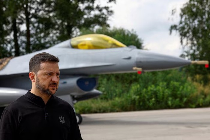 Ukraines President Volodymyr Zelenskiy speaks to the media in a front of an F-16 fighting aircraft after marking the Day of the Ukrainian Air Forces, amid Russias attack on Ukraine, in an undisclosed location, Ukraine August 4, 2024. REUTERS/Valentyn Ogirenko/File Photo Purchase Licensing Rights
