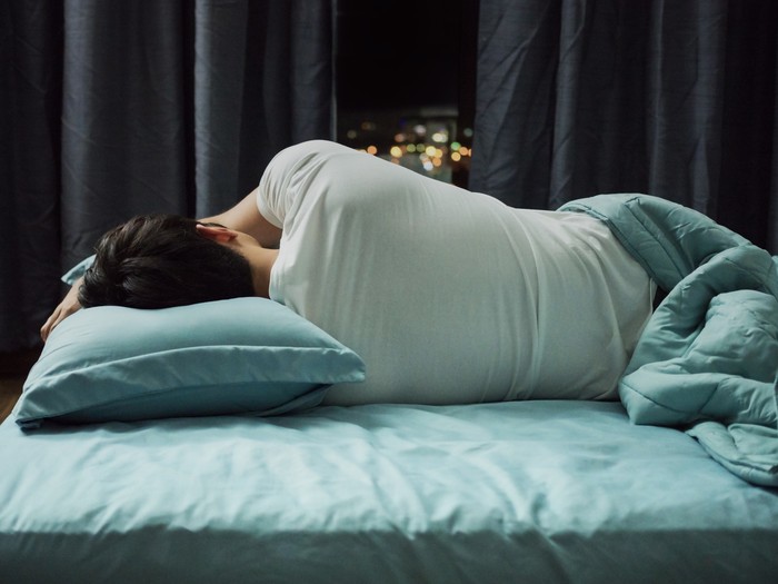 Man sleeping in bed at night