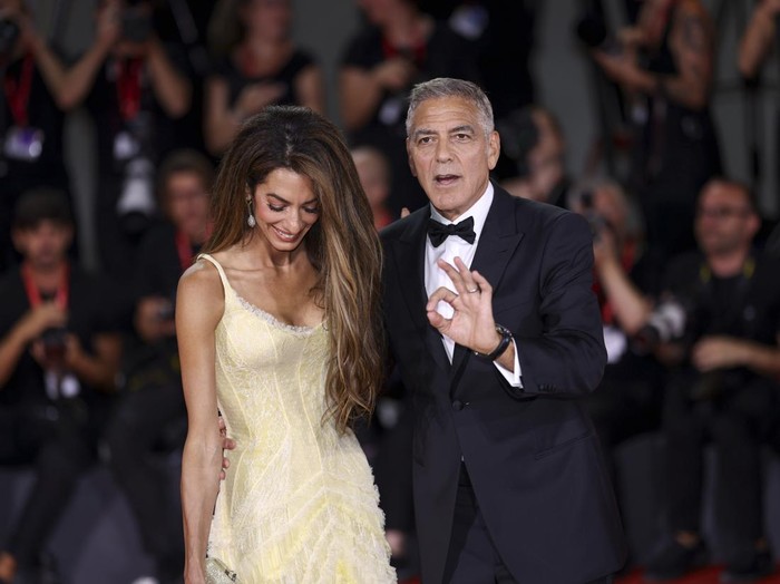 Amal Clooney, left, and George Clooney pose for photographers upon arrival for the premiere of the film Wolfs during the 81st edition of the Venice Film Festival in Venice, Italy, on Sunday, Sept. 1, 2024. (Photo by Joel C Ryan/Invision/AP)