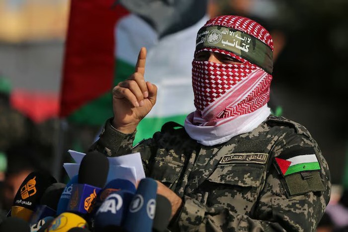 Abu Ubaida, the spokesman of the Izz el-Deen al-Qassam Brigades, gestures as he speaks during an anti-Israel military show in the southern Gaza Strip November 11, 2019. REUTERS/Ibraheem Abu Mustafa/ File Photo Purchase Licensing Rights