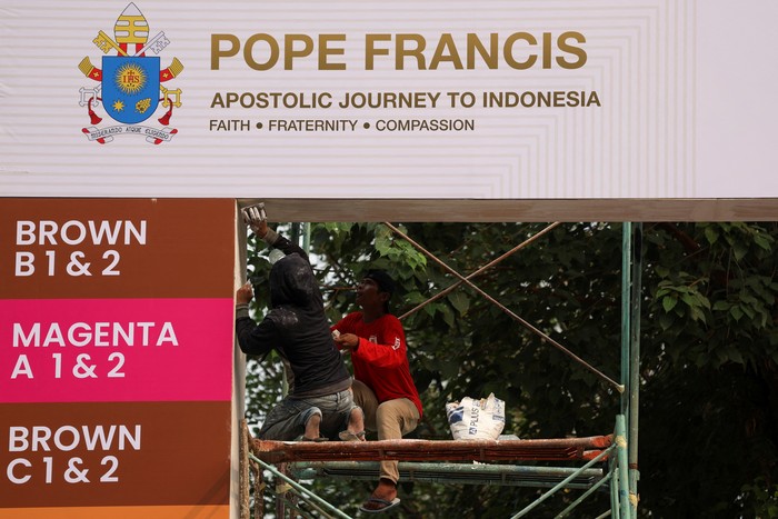 Women walk at Gelora Bung Karno Main Stadium while they prepare for a mass on the day of Pope Francis visit, in Jakarta, Indonesia, September 3, 2024. REUTERS/Ajeng Dinar Ulfiana