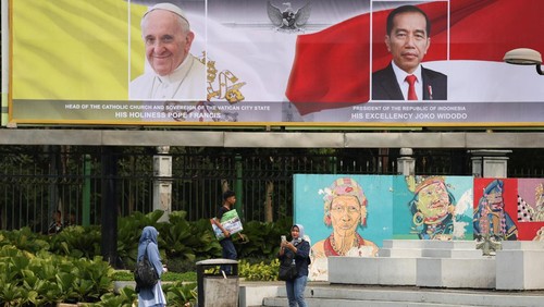 Women walk at Gelora Bung Karno Main Stadium while they prepare for a mass on the day of Pope Francis visit, in Jakarta, Indonesia, September 3, 2024. REUTERS/Ajeng Dinar Ulfiana