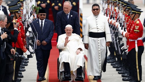 Indonesias religious affairs minister Yaqut Cholil Qoumas walks alongside Pope Francis at Soekarno-Hatta International Airport during the Popes apostolic visit to Asia, in Tangerang near Jakarta, Indonesia, September 3, 2024. REUTERS/Willy Kurniawan