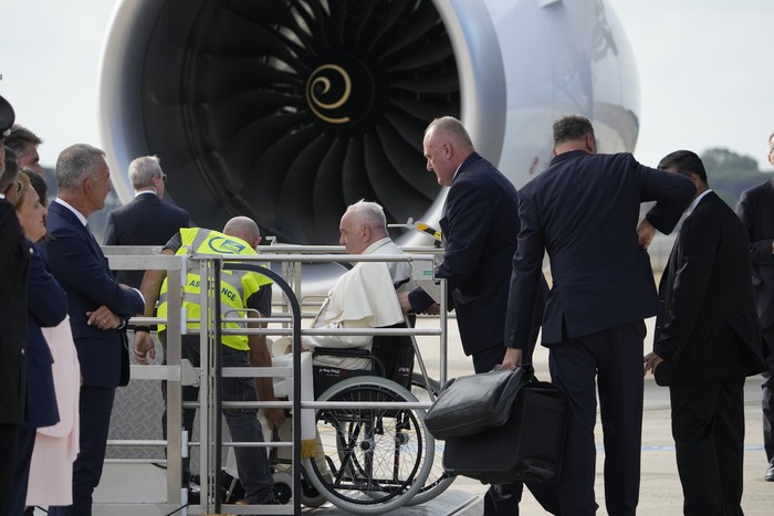 Pope Francis on a wheelchair boards his flight to Asia at Romes Leonardo Da Vinci International airport in Fiumicino, some 30 kilometers west of Rome, Monday, Sept. 2, 2024. Francis will clock 32,814 kilometers (20,390 miles) by air during his Sept. 2-13 visit to Indonesia, Papua New Guinea, East Timor and Singapore, far surpassing any of his previous 44 foreign trips and notching one of the longest papal trips ever, both in terms of days on the road and distances traveled. (AP Photo/Andrew Medichini)