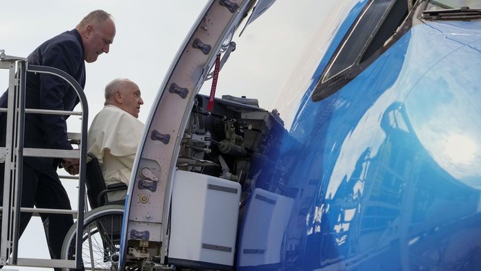 Pope Francis on a wheelchair boards his flight to Asia at Romes Leonardo Da Vinci International airport in Fiumicino, some 30 kilometers west of Rome, Monday, Sept. 2, 2024. Francis will clock 32,814 kilometers (20,390 miles) by air during his Sept. 2-13 visit to Indonesia, Papua New Guinea, East Timor and Singapore, far surpassing any of his previous 44 foreign trips and notching one of the longest papal trips ever, both in terms of days on the road and distances traveled. (AP Photo/Andrew Medichini)