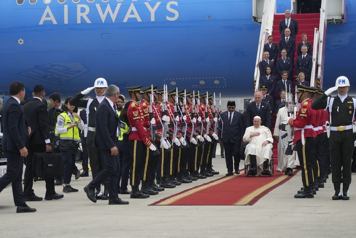 Pope Francis is welcomed by Indonesias Minister for Religious Affairs Yaqut Cholil Qoumas, at his right, soon after landing at Jakartas International airport Soekarno Hatta, Tuesday, Sept. 3, 2024. Pope Francis arrived in Indonesia on Tuesday at the start of the longest trip of his pontificate, hoping to encourage its Catholic community and celebrate the tradition of interfaith harmony in a country with the worlds largest Muslim population. (AP Photo/Gregorio Borgia)