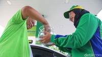 Seorang konsumen mengambil kupon undian yang diberikan di Hari Pelanggan Nasional 2024 tersebut.  