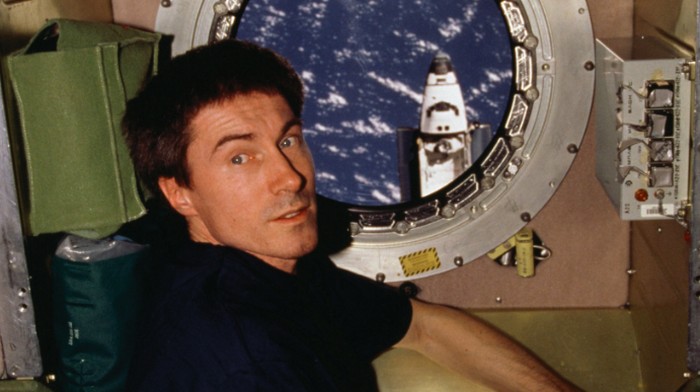 Kosmonot Rusia, Sergei Krikalev saat di lubang intip pada modul layanan Zvezda di Stasiun Luar Angkasa Internasional selama Ekspedisi 1, ketika Pesawat Ulang Alik Atlantis. Awan yang tersebar di atas Pasifik Barat terlihat dalam pemandangan jendela.