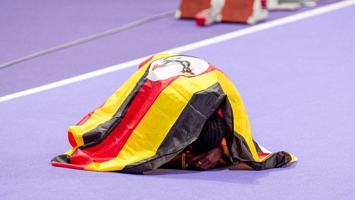 PARIS, FRANCE - AUGUST 6: Peruth Chemutai of Uganda holding flag after competing in the Womens 3000m Steeplechase Final during Day 11 of Athletics - Olympic Games Paris 2024 at Stade de France on August 6, 2024 in Paris, France. (Photo by Joris Verwijst/BSR Agency/Getty Images)