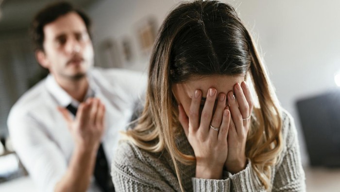 Husband and wife are arguing at home. Angry man is yelling at his wife.