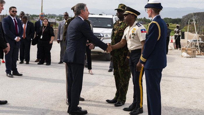 U.S. Secretary of State Antony Blinken, in sunglasses, and Commander of the Multinational Security Support Mission Commander Godfrey Otunge speak at the U.S. Chief of Mission Residence in Port-au-Prince, Haiti, Thursday, Sept. 5, 2024. (Roberto Schmidt/Pool photo via AP)