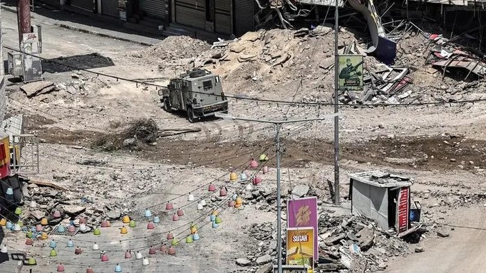 Israeli army armored vehicles move along an excavated section of a road in the center of Jenin in the occupied West Bank on September 5, 2024 amid ongoing military operations in the Palestinian territories. (AFP)