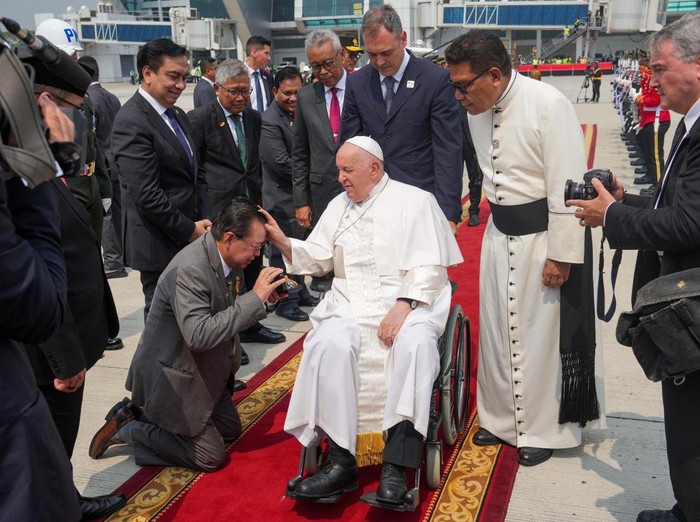 Pope Francis is assisted out of a car ahead of his departure from Jakarta Soekarno-Hatta International Airport, Indonesia, Friday, Sept. 6, 2024. Tatan Syuflana/Pool via REUTERS