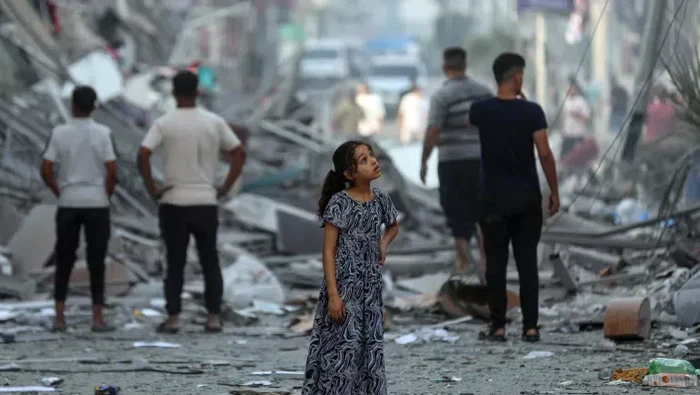 Seorang anak berusia 7 tahun bernama Amal, sedang di tengah lingkungannya di Gaza setelah rumah-rumah tetangganya rata dengan tanah.