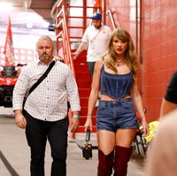 Korset denim yang dikenakannya menampilkan desain modern sekaligus edgy, terlebih lagi dengan boots selutut warna merah marun dari koleksi Giuseppe Zanotti. Clutch hitam Louis Vuitton melengkapi busananya. Foto: Dok. Getty Images