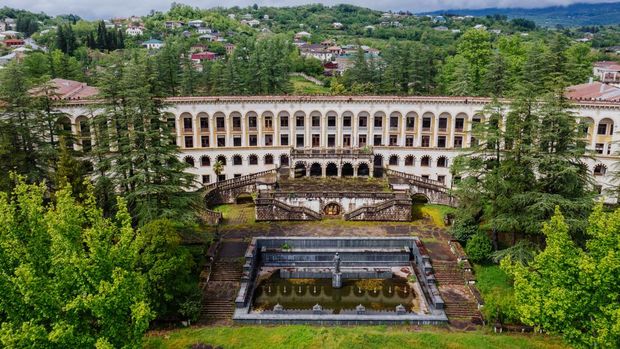 Aerial view of ruined overgrown old abandoned Soviet sanatorium Miner, Tskaltubo, Georgia