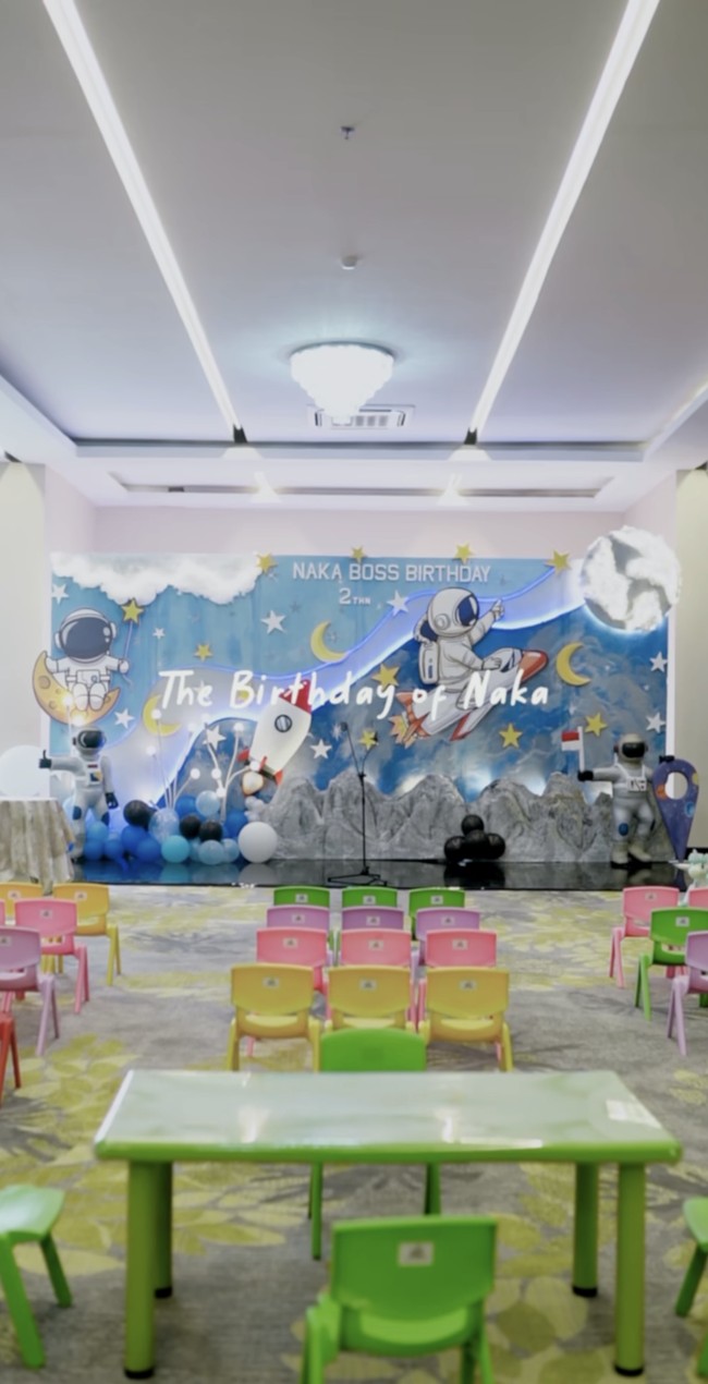 Meriah dengan tema ruang angkasa, gambar planet, pesawat ruang angkasa, serta astronaut tampak menghiasi ruangan acara ulang tahun Naka. Bangku warna-warni untuk teman-teman Naka yang hadir juga sudah dipersiapkan dan berjajar rapi Foto: Instagram/@indahpermatas