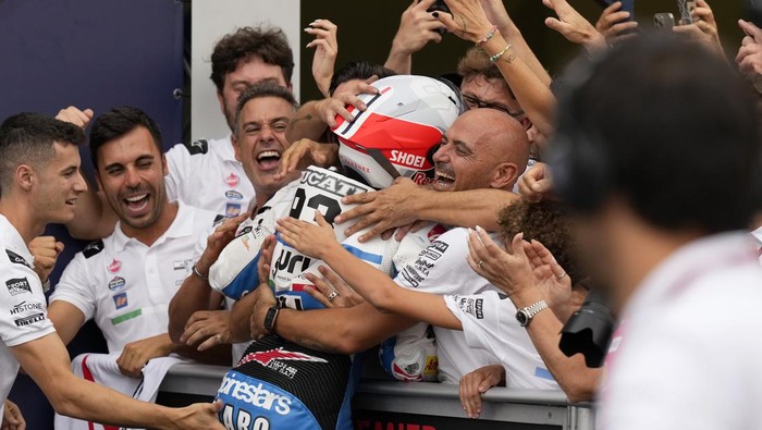 MotoGP rider Marc Marquez of Spain celebrates with his team after winning the San Marino Motorcycle Grand Prix at the Misano circuit in Misano Adriatico, Italy, Sunday, Sept. 8, 2024. (AP Photo/Antonio Calanni)