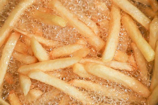Close up of Frying french fries in the fryer in hot oil.