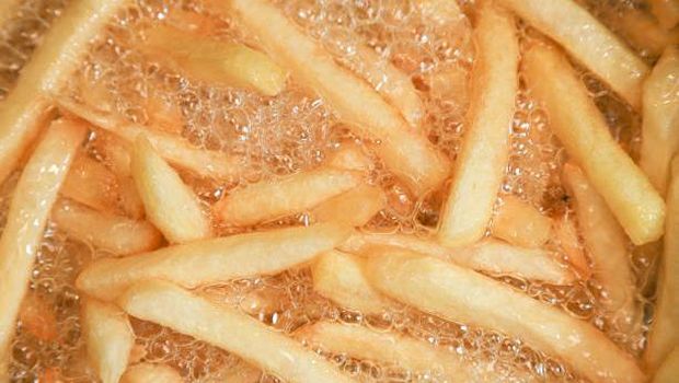 Close up of Frying french fries in the fryer in hot oil.
