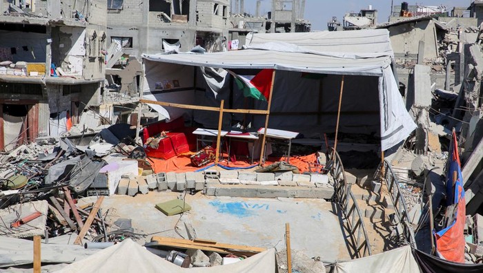 Palestinian teacher Israa Abu Mustafa gives a class to students inside a tent set up on the rubble of her house as war disrupts a new school year, amid the Israel-Hamas conflict, in Khan Younis, in the southern Gaza Strip, September 4, 2024. REUTERS/Hatem Khaled