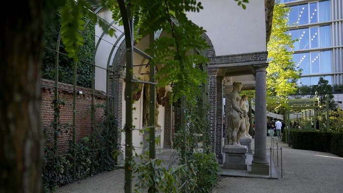 A man walks by a fountain in the newly restored garden of the Rubens House in Antwerp, Belgium, Wednesday, Aug. 28, 2024. (AP Photo/Virginia Mayo)