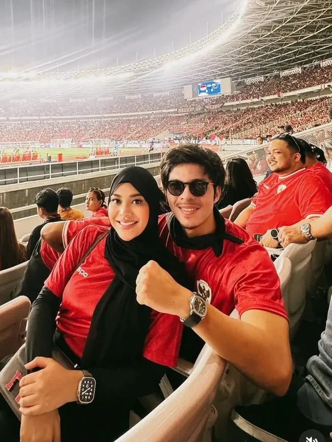 Putaran ketiga Grup C kualifikasi Piala Dunia 2026 zona Asia yang mempertemukan Indonesia dan Australia tadi malam menjadi momen kencan bagi pasangan Atta Halilintar dan Aurel Hermansyah. Keduanya kompak dengan kaus merah. (Foto: Instagram)