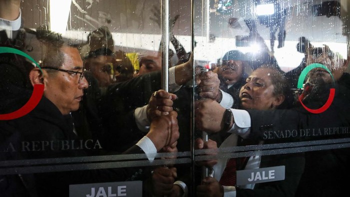 Massa Geruduk Senat Meksiko Protes Reformasi Yudisial yang Kontroversial Demonstrators enter the Senate building as a highly contested judicial reform proposal is debated, following its approval by the Chamber of Deputies and backing by senators at the commission stage, in Mexico City, Mexico, September 10, 2024. REUTERS/Paola Garcia