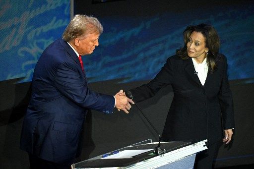 US Vice President and Democratic presidential candidate Kamala Harris (R) shakes hands with former US President and Republican presidential candidate Donald Trump during a presidential debate at the National Constitution Center in Philadelphia, Pennsylvania, on September 10, 2024. (Photo by SAUL LOEB / AFP)