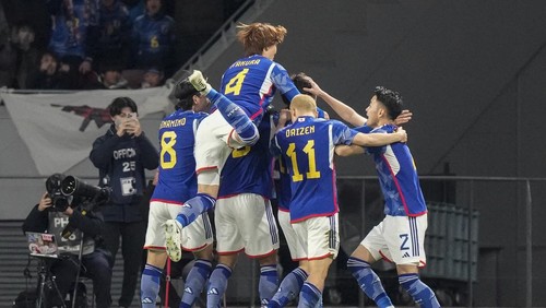 Japans players celebrates scoring their first goal during the FIFA World Cup 2026 and AFC Asian Cup 2027 preliminary joint qualification round 2 match between Japan and North Korea at the National Stadium Thursday, March 21, 2024, in Tokyo. (AP Photo/Eugene Hoshiko)
