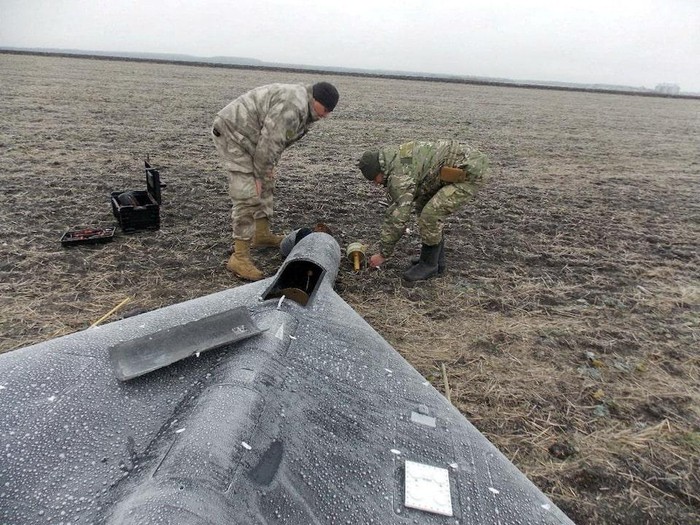 Members of police demining unit remove a warhead from a Russian kamikaze unmanned aerial vehicle landed by a radio electronic warfare during one of latest drone strikes, amid Russias attack on Ukraine, in an unknown location in Ukraine, in this handout picture released January 26, 2024. Press service of the National Police of Ukraine/Handout via REUTERS/File Photo Purchase Licensing Rights