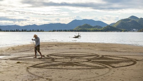 A drone view shows artist Nikola Faler working on sand drawing in the mouth of the river Neretva during the 4th Sand Art Festival near Ploce, Croatia, September 14, 2024. REUTERS/Antonio Bronic     TPX IMAGES OF THE DAY
