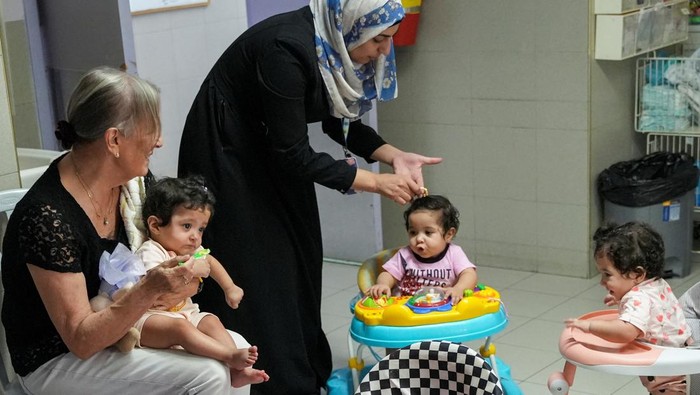 Palestinian triplets from al-Bayouk family, born prematurely and separated from their mother who had to leave them at hospital in Jerusalem to recover as she had to return to Gaza after her Israeli-issued permit expired before the ongoing Israel-Hamas conflict, are shown to their mother Hanan during a video call, at Makassed hospital in East Jerusalem September 5, 2024. Since the war began, Israel has not been issuing permits for Gaza residents to visit Jerusalem, resulting in the separation of Hanan from her triplets. REUTERS/Latifeh Abdellatif     TPX IMAGES OF THE DAY