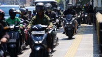 Pemotor nekat melintasi trotoar untuk menghindari macet di Jalan Matraman Raya.