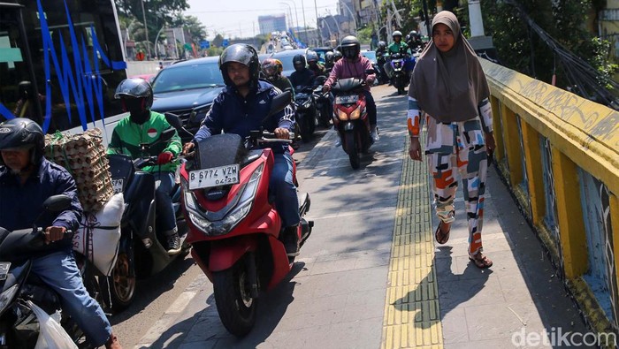 Jangan Ditiru! Pemotor Serobot Jalur Pejalan Kaki di Matraman Sejumlah pengendara sepeda motor nekat menerobos trotoar di Jalan Matraman Raya, Jakarta, Selasa (17/9/2024).