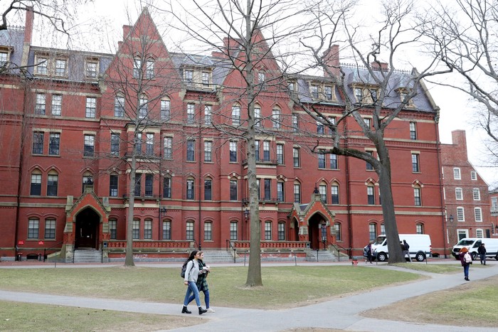 CAMBRIDGE, MASSACHUSETTS - MARCH 12: Students walk through Harvard Yard on the campus of Harvard University on March 12, 2020 in Cambridge, Massachusetts. Students have been asked to move out of their dorms by March 15 due to the Coronavirus (COVID-19) risk. All classes will be moved online for the rest of the spring semester.   Maddie Meyer/Getty Images/AFP (Photo by Maddie Meyer / GETTY IMAGES NORTH AMERICA / Getty Images via AFP)