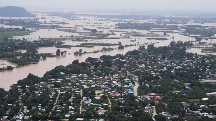 Local residents travel by boat on a flooded road in Naypyitaw, Myanmar, Sunday, Sept. 15, 2024. (AP Photo/Aung Shine Oo)