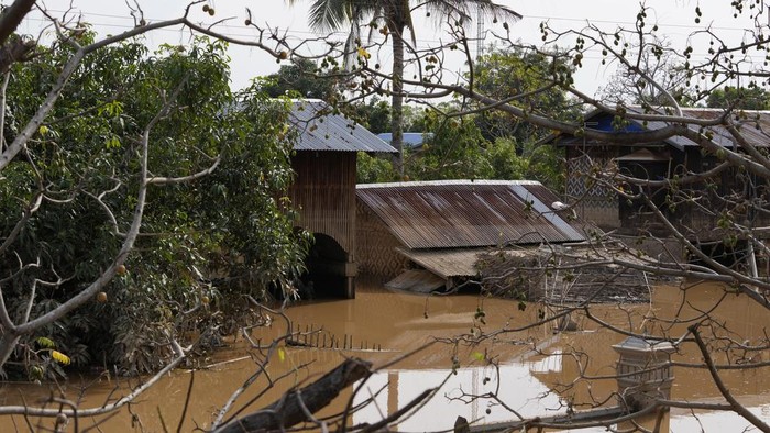Local residents travel by boat on a flooded road in Naypyitaw, Myanmar, Sunday, Sept. 15, 2024. (AP Photo/Aung Shine Oo)