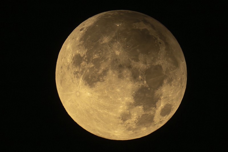 A supermoon rises behind clouds over Larnaca international airport in the eastern Mediterranean island of Cyprus, on Tuesday, Sept. 17, 2024. (AP Photo/Petros Karadjias)