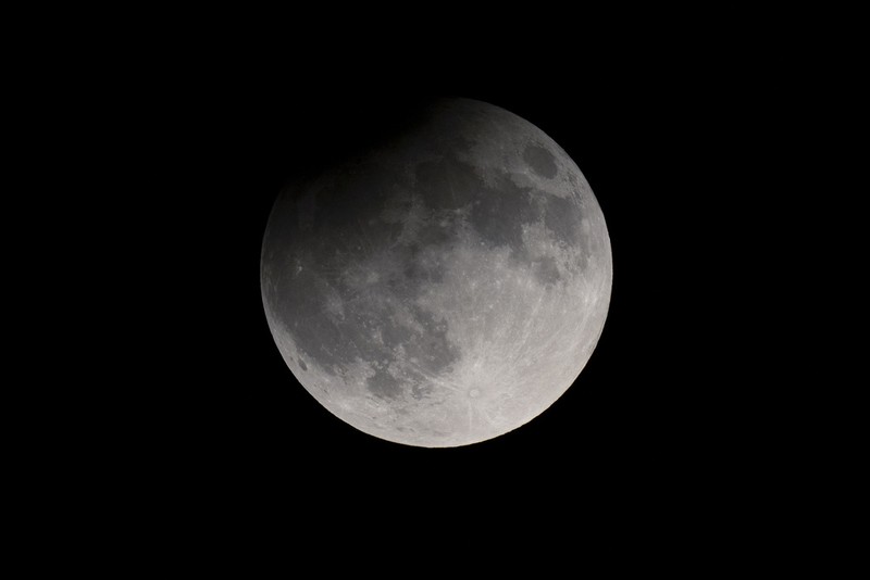 A supermoon rises behind clouds over Larnaca international airport in the eastern Mediterranean island of Cyprus, on Tuesday, Sept. 17, 2024. (AP Photo/Petros Karadjias)
