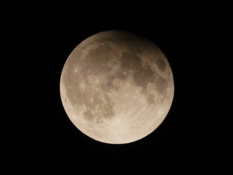 A supermoon rises behind clouds over Larnaca international airport in the eastern Mediterranean island of Cyprus, on Tuesday, Sept. 17, 2024. (AP Photo/Petros Karadjias)