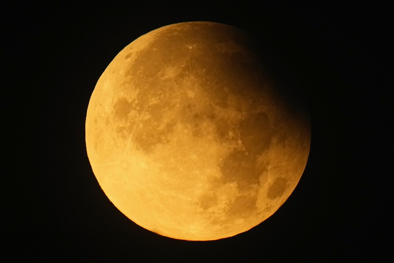 A supermoon rises behind clouds over Larnaca international airport in the eastern Mediterranean island of Cyprus, on Tuesday, Sept. 17, 2024. (AP Photo/Petros Karadjias)