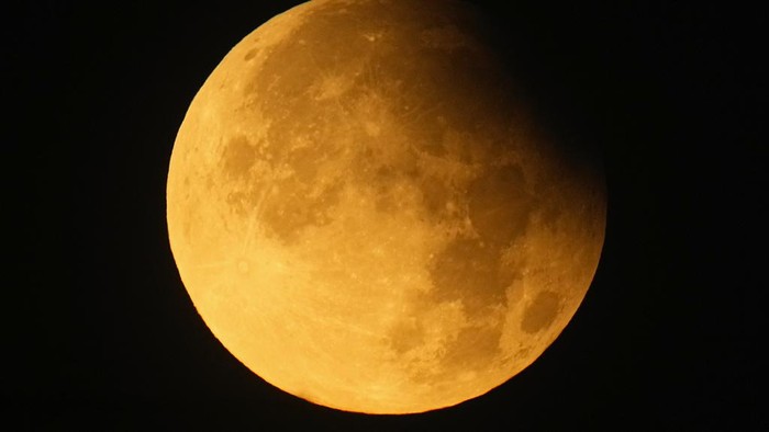 A supermoon rises behind clouds over Larnaca international airport in the eastern Mediterranean island of Cyprus, on Tuesday, Sept. 17, 2024. (AP Photo/Petros Karadjias)