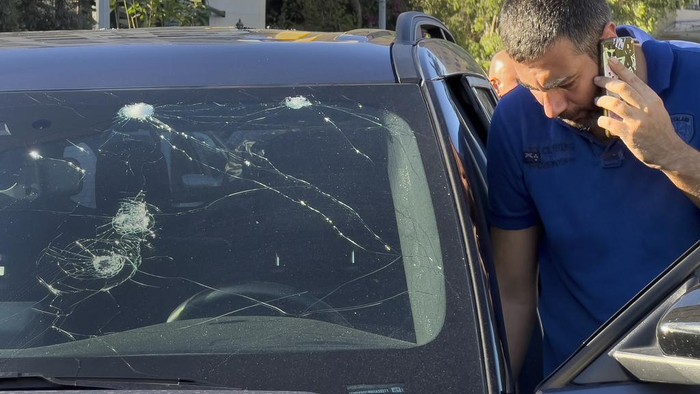 A police officer inspects a car in which a hand-held pager exploded, in Beirut, Lebanon, Tuesday, Sept. 17, 2024. (AP Photo/Hussein Malla)