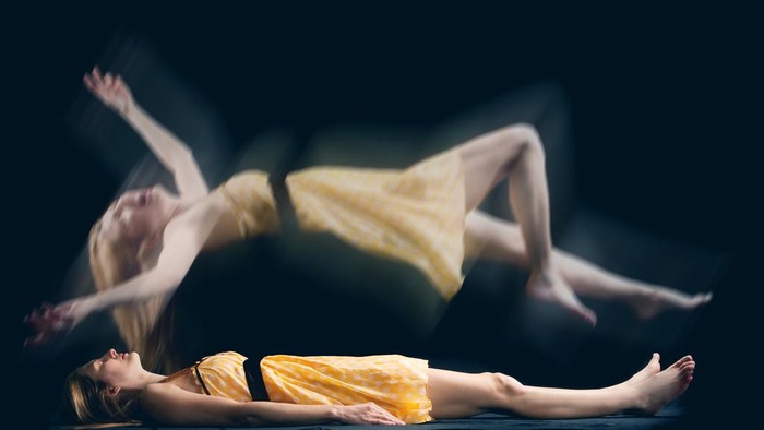 A conceptual image of a woman falling in her sleep.