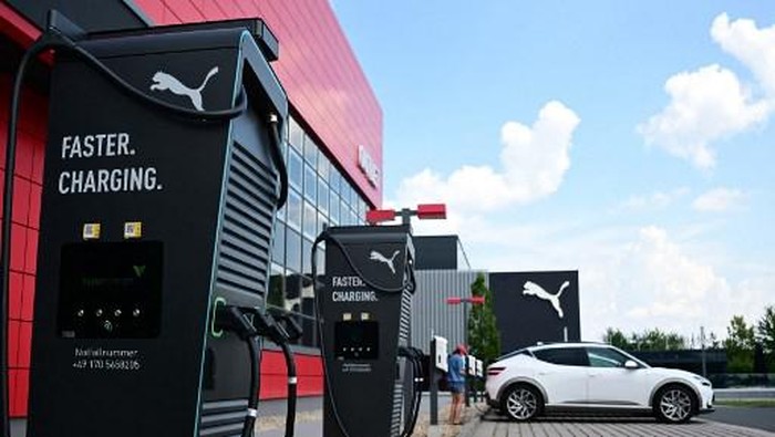 Electric car charging stations are seen outside the outlet of German multinational sportswear manufacturer Puma in Herzogenaurach, southern Germany on June 27, 2024. (Photo by Tobias SCHWARZ / AFP)