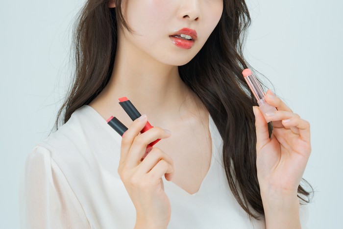 Young woman with make-up and lipstick and white background
