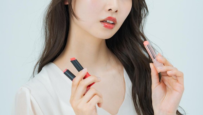 Young woman with make-up and lipstick and white background